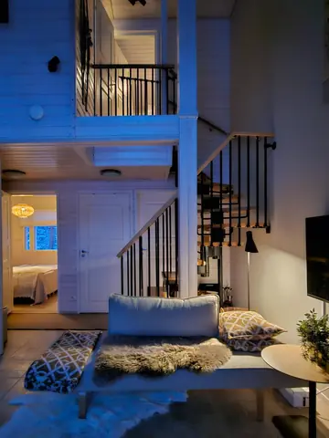 Open-plan living room and kitchen with the staircase to the upper floor